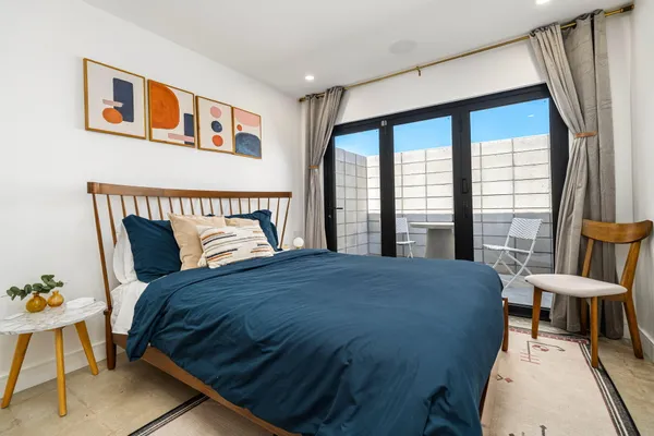 a bedroom with a bed and a large window