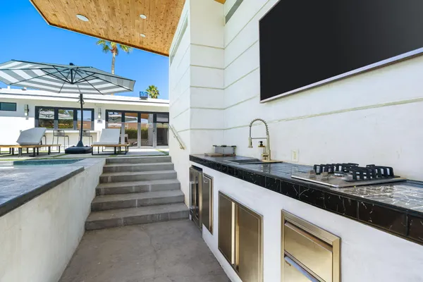 a kitchen with stainless steel appliances granite countertop a stove and a sink