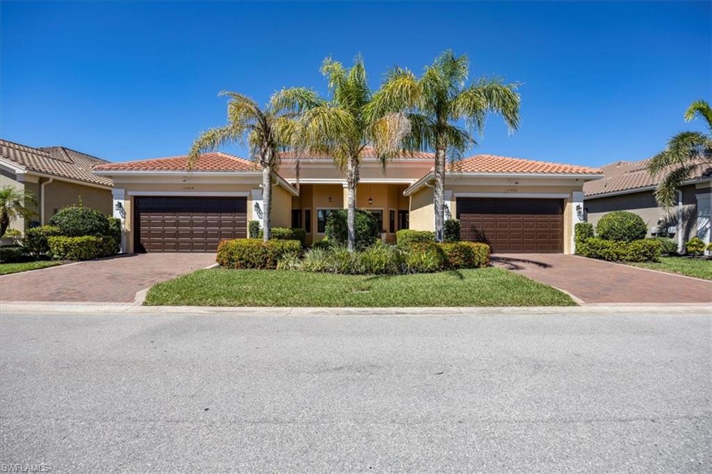 13422 Silktail Drive Naples, FL 34109 - Photo 1 of 37 View of front of home featuring a tiled roof, decorative driveway, a garage, and stucco siding