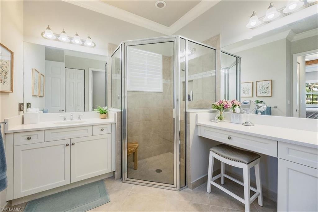 13422 Silktail Drive Naples, FL 34109 - Photo 15 of 37 Full bath with vanity, crown molding, and a stall shower