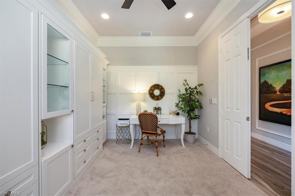 13422 Silktail Drive Naples, FL 34109 - Photo 18 of 37 Office area with visible vents, light colored carpet, crown molding, and a ceiling fan