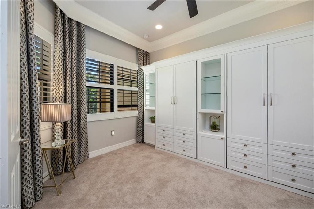 13422 Silktail Drive Naples, FL 34109 - Photo 19 of 37 den with Murphy Beds, crown molding, baseboards, light carpet, recessed lighting, and a ceiling fan
