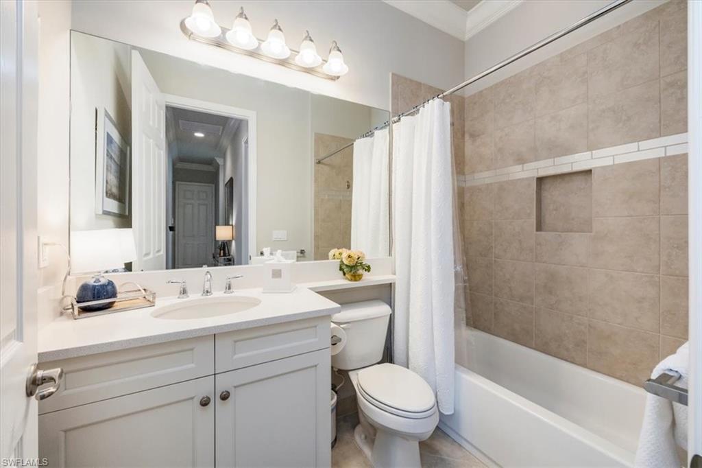 13422 Silktail Drive Naples, FL 34109 - Photo 21 of 37 Bathroom with vanity, crown molding, toilet, and shower / bath combo with shower curtain