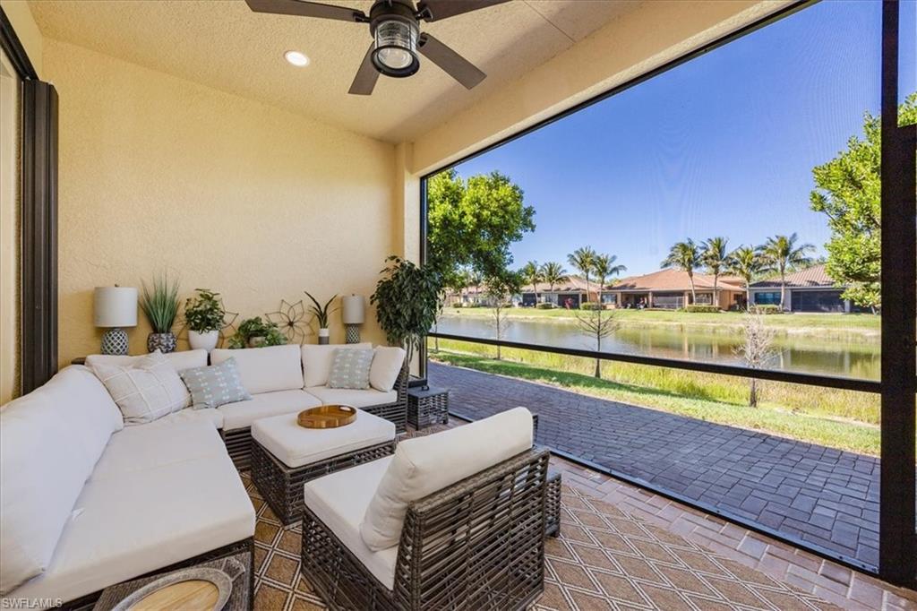 13422 Silktail Drive Naples, FL 34109 - Photo 24 of 37 Sunroom featuring an outdoor hangout area, a water view, and ceiling fan