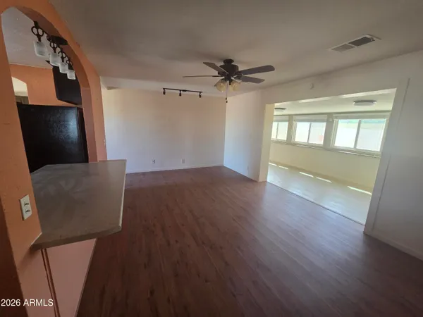 wooden floor in an empty room with a window