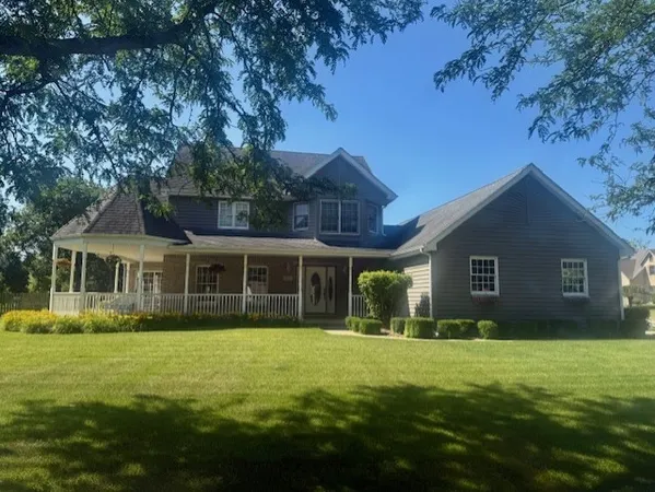 a front view of house with yard and green space