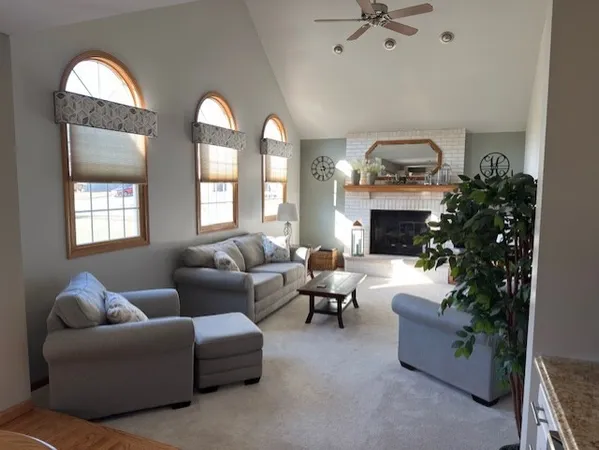 a living room with furniture and a fireplace