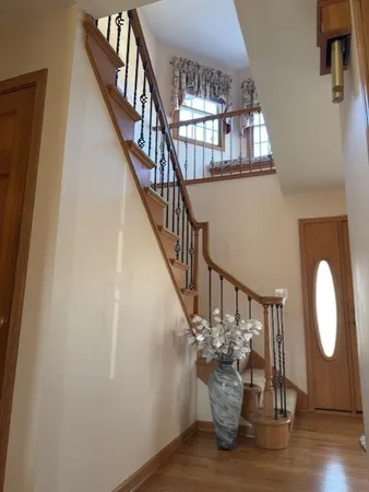 a view of entryway and hall with wooden floor