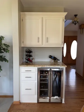 a kitchen with a stove and white cabinets