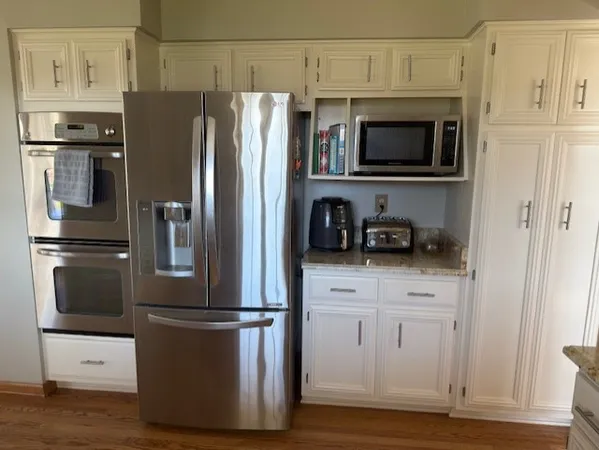 a kitchen with stainless steel appliances a refrigerator stove and microwave