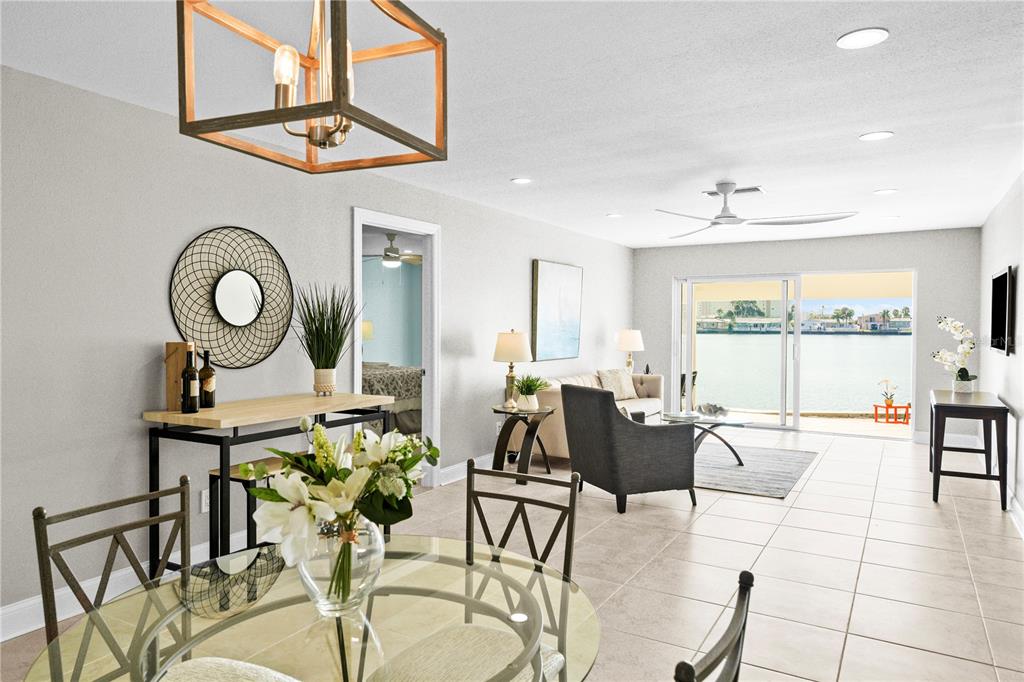 642 Boca Ciega Point Boulevard South St. Petersburg, FL 33708 - Photo 11 of 54 a view of a dining room with furniture a chandelier and a window