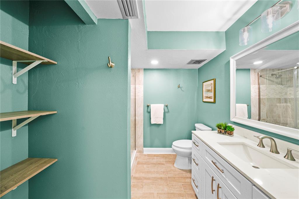 642 Boca Ciega Point Boulevard South St. Petersburg, FL 33708 - Photo 32 of 54 a bathroom with a sink a toilet and shower