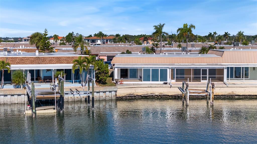 642 Boca Ciega Point Boulevard South St. Petersburg, FL 33708 - Photo 41 of 54 a view of house with swimming pool yard and outdoor seating
