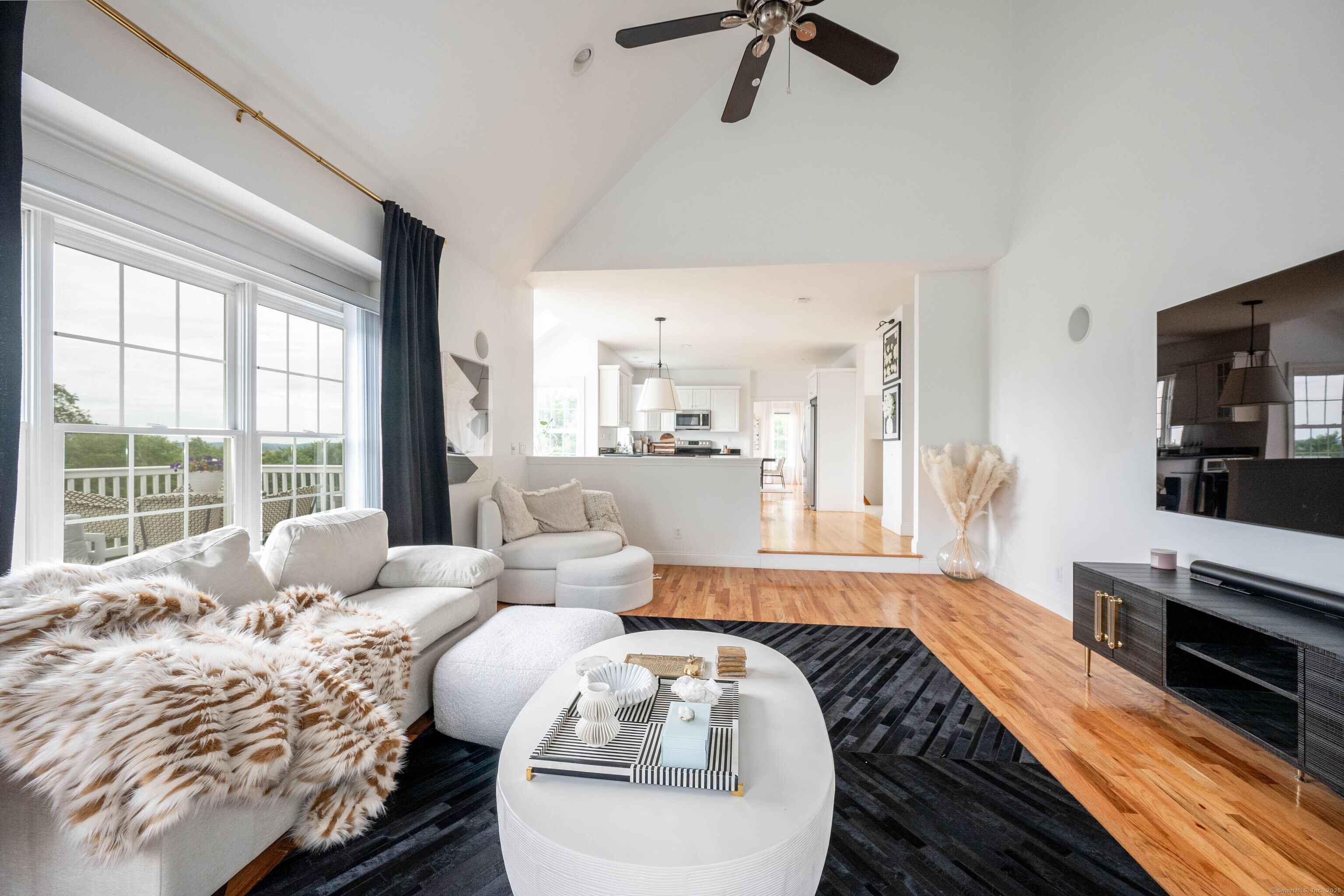 557 Upper Grassy Hill Road Woodbury, CT 06798 - Photo 12 of 40 a living room with furniture and a flat screen tv
