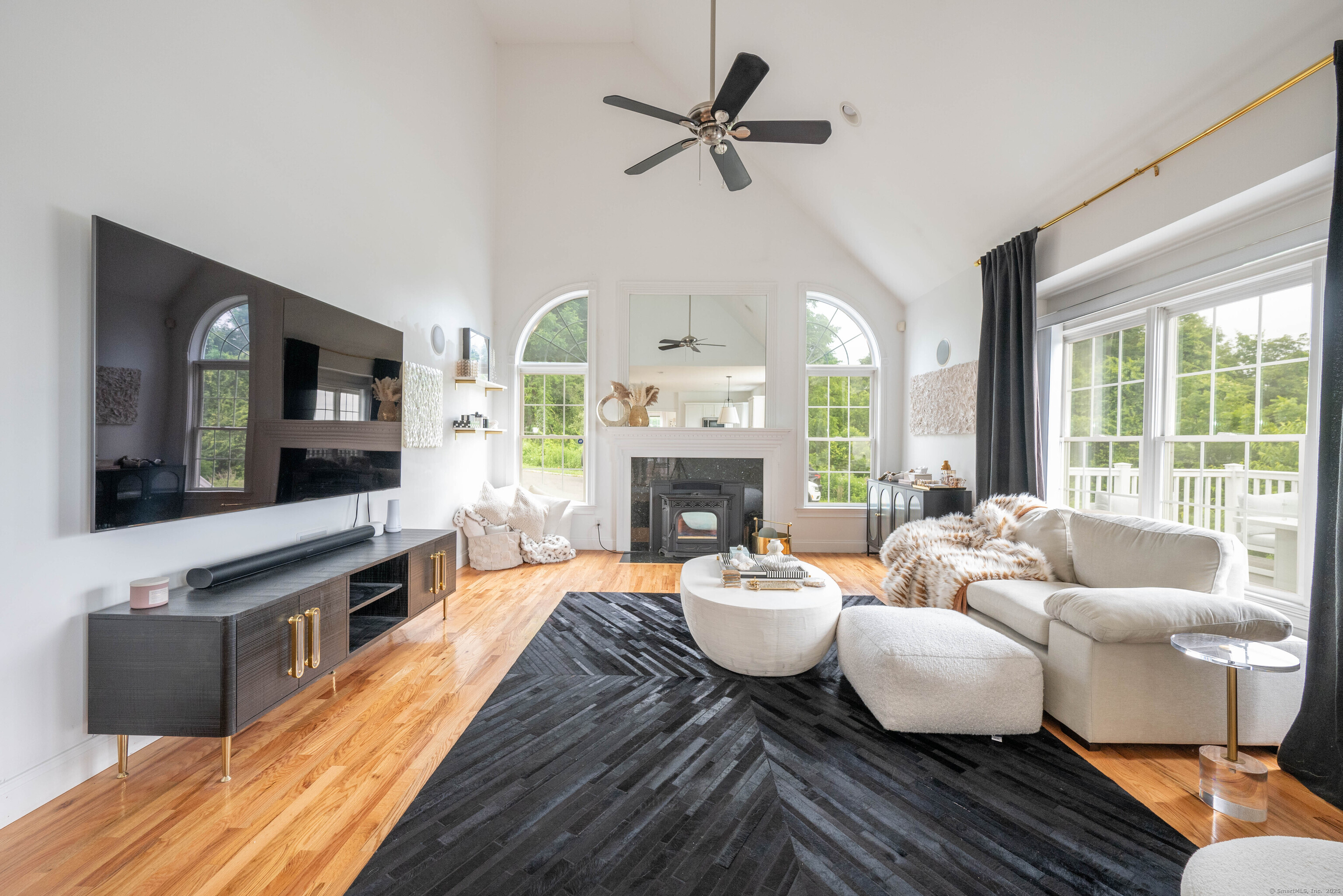 557 Upper Grassy Hill Road Woodbury, CT 06798 - Photo 13 of 40 a living room with fireplace furniture and a large window