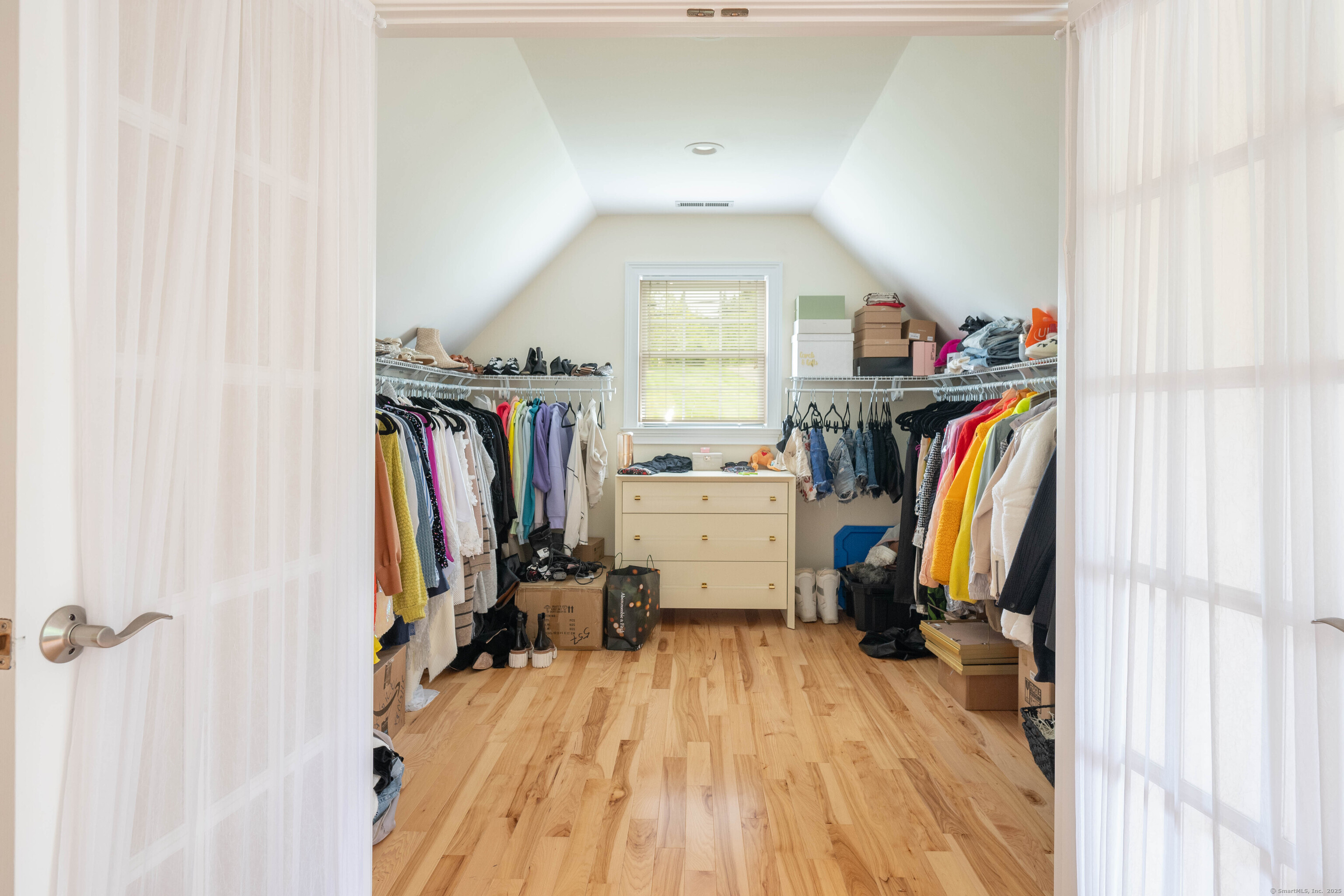 557 Upper Grassy Hill Road Woodbury, CT 06798 - Photo 19 of 40 a view of walk in closet with clothes and shoes