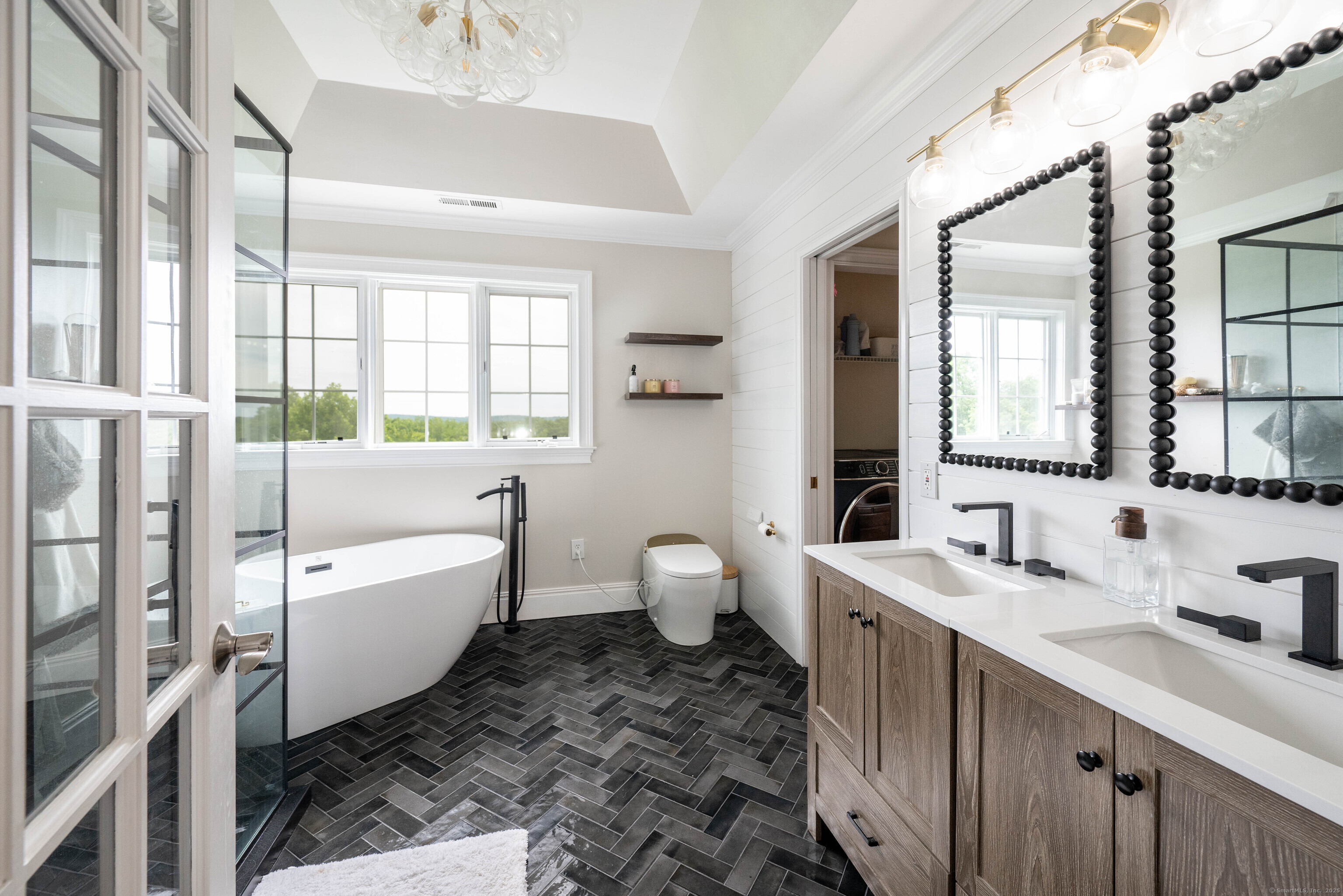 557 Upper Grassy Hill Road Woodbury, CT 06798 - Photo 20 of 40 a bathroom with a double vanity sink a toilet and shower