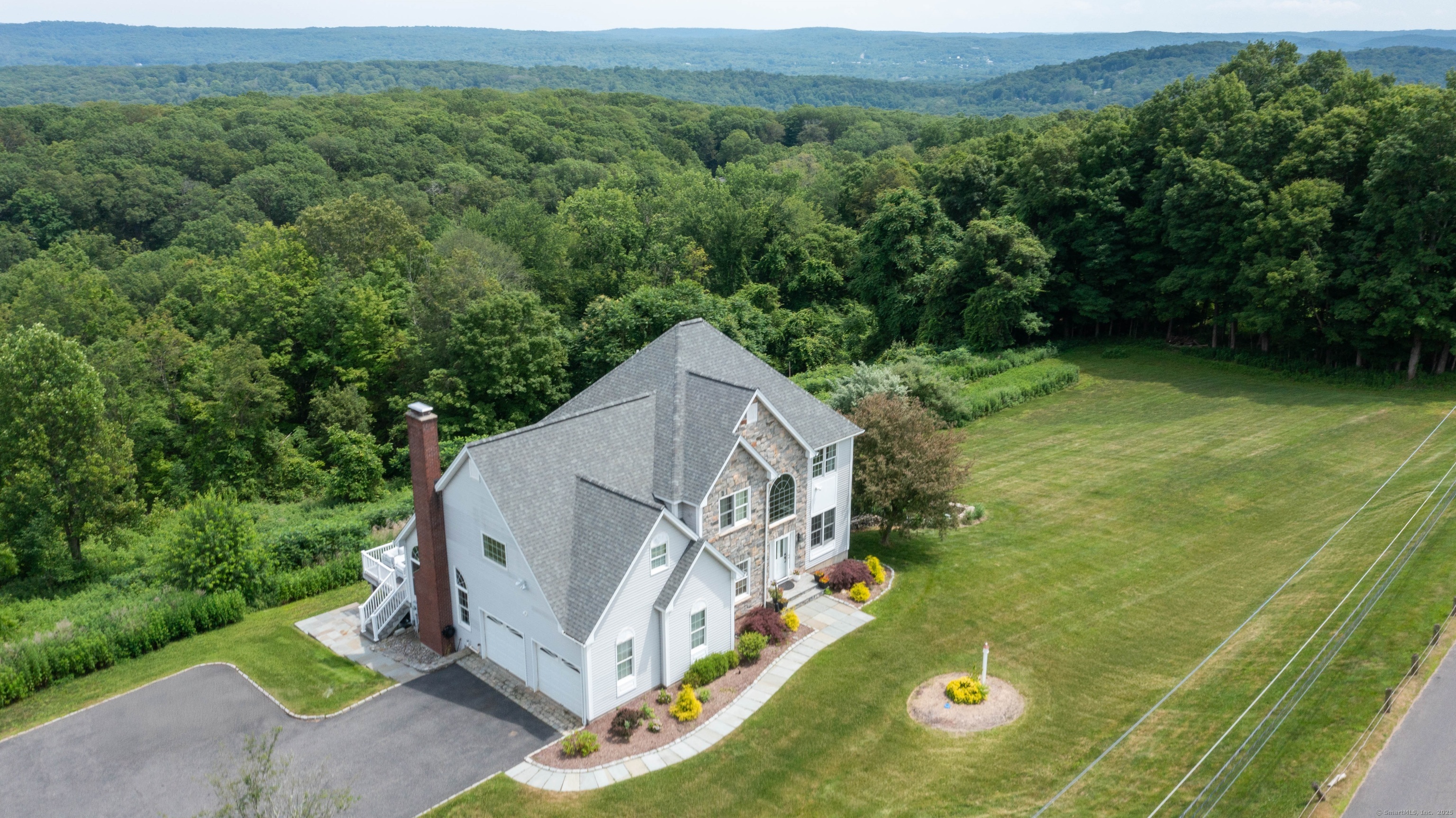 557 Upper Grassy Hill Road Woodbury, CT 06798 - Photo 2 of 40 a view of a houses with a yard