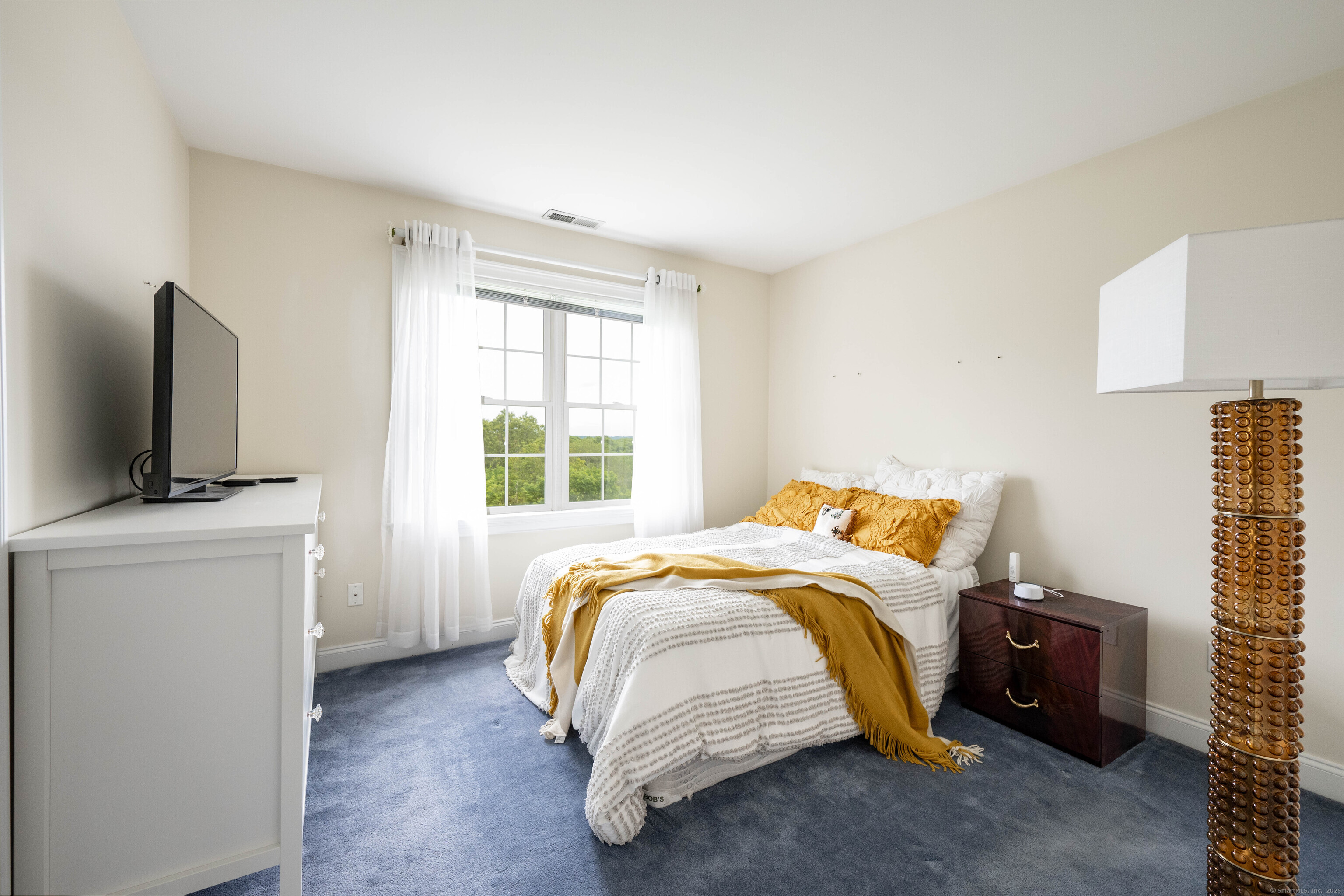 557 Upper Grassy Hill Road Woodbury, CT 06798 - Photo 24 of 40 a bed sitting in a bedroom next to a window