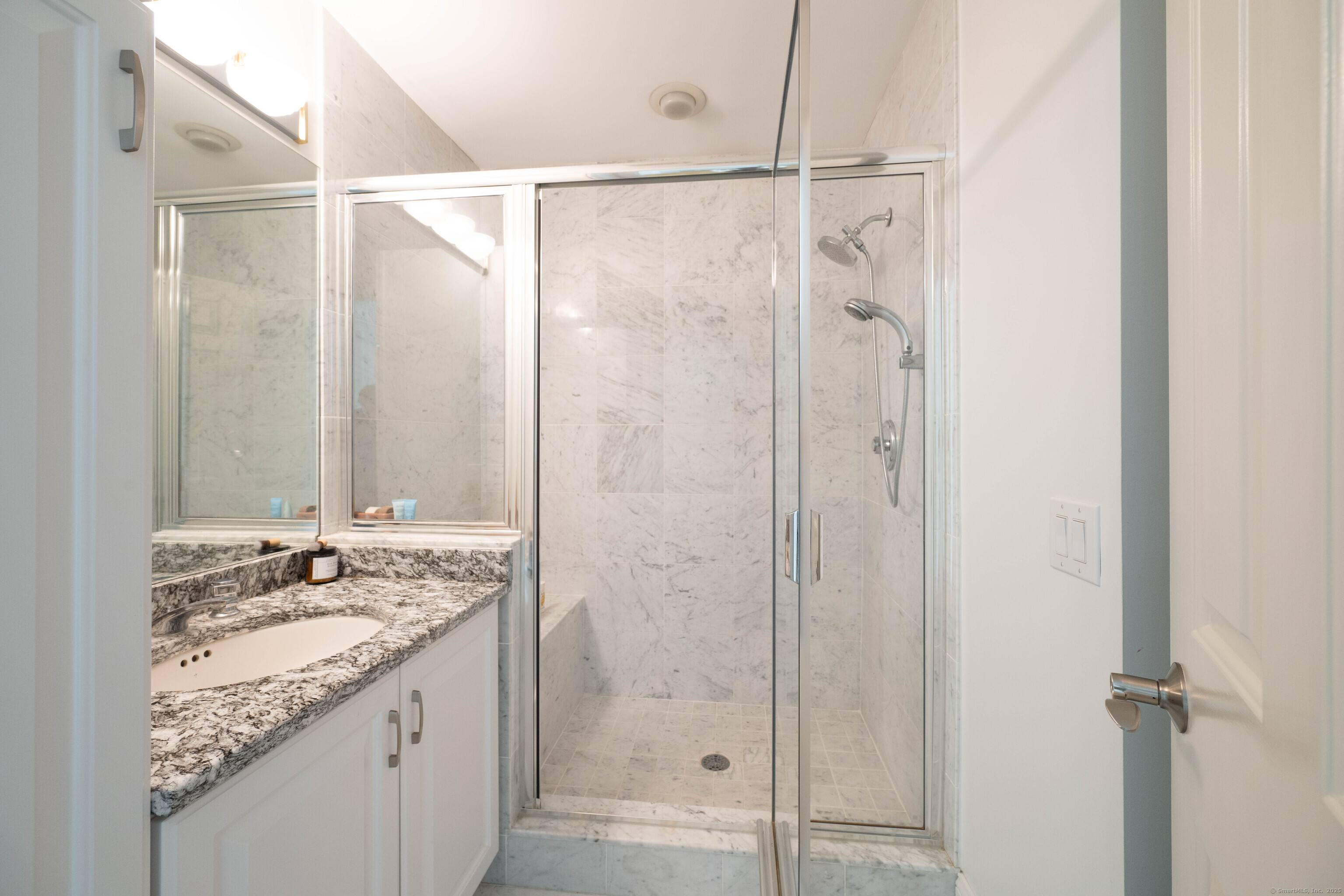 557 Upper Grassy Hill Road Woodbury, CT 06798 - Photo 25 of 40 a bathroom with a granite countertop shower and a sink