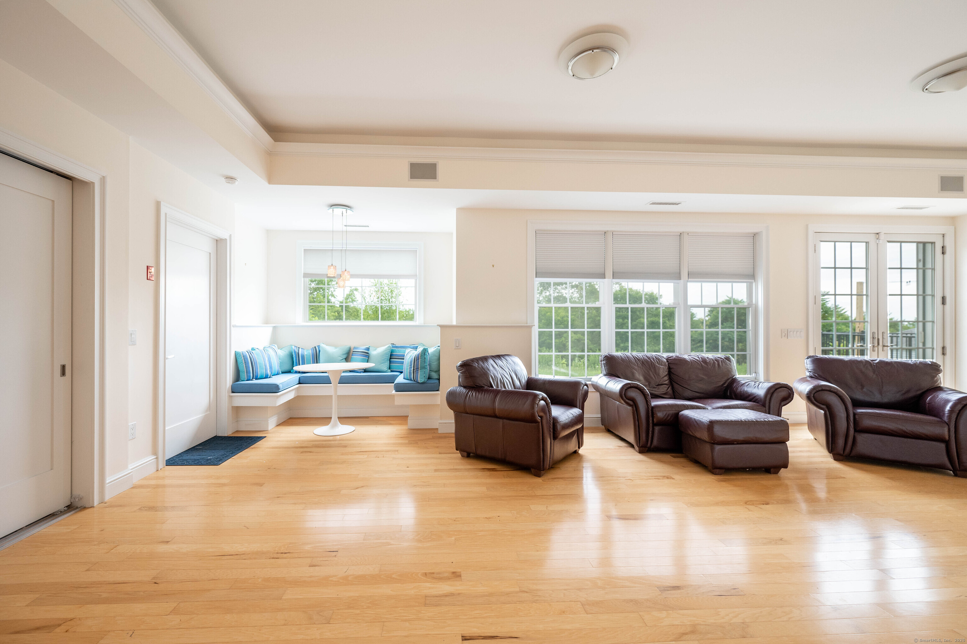 557 Upper Grassy Hill Road Woodbury, CT 06798 - Photo 27 of 40 a living room with furniture and large windows