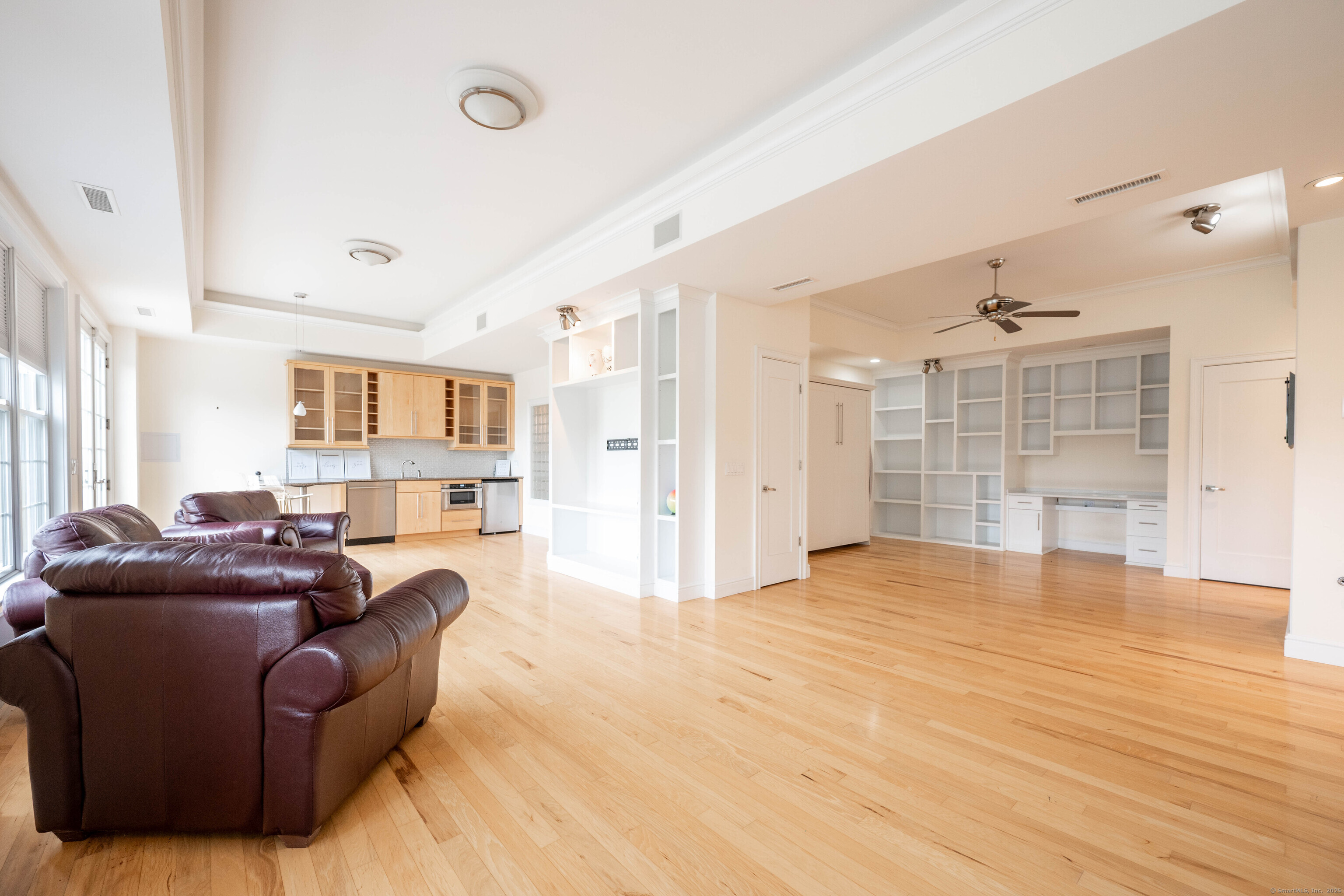 557 Upper Grassy Hill Road Woodbury, CT 06798 - Photo 30 of 40 a living room with furniture and a wooden floor