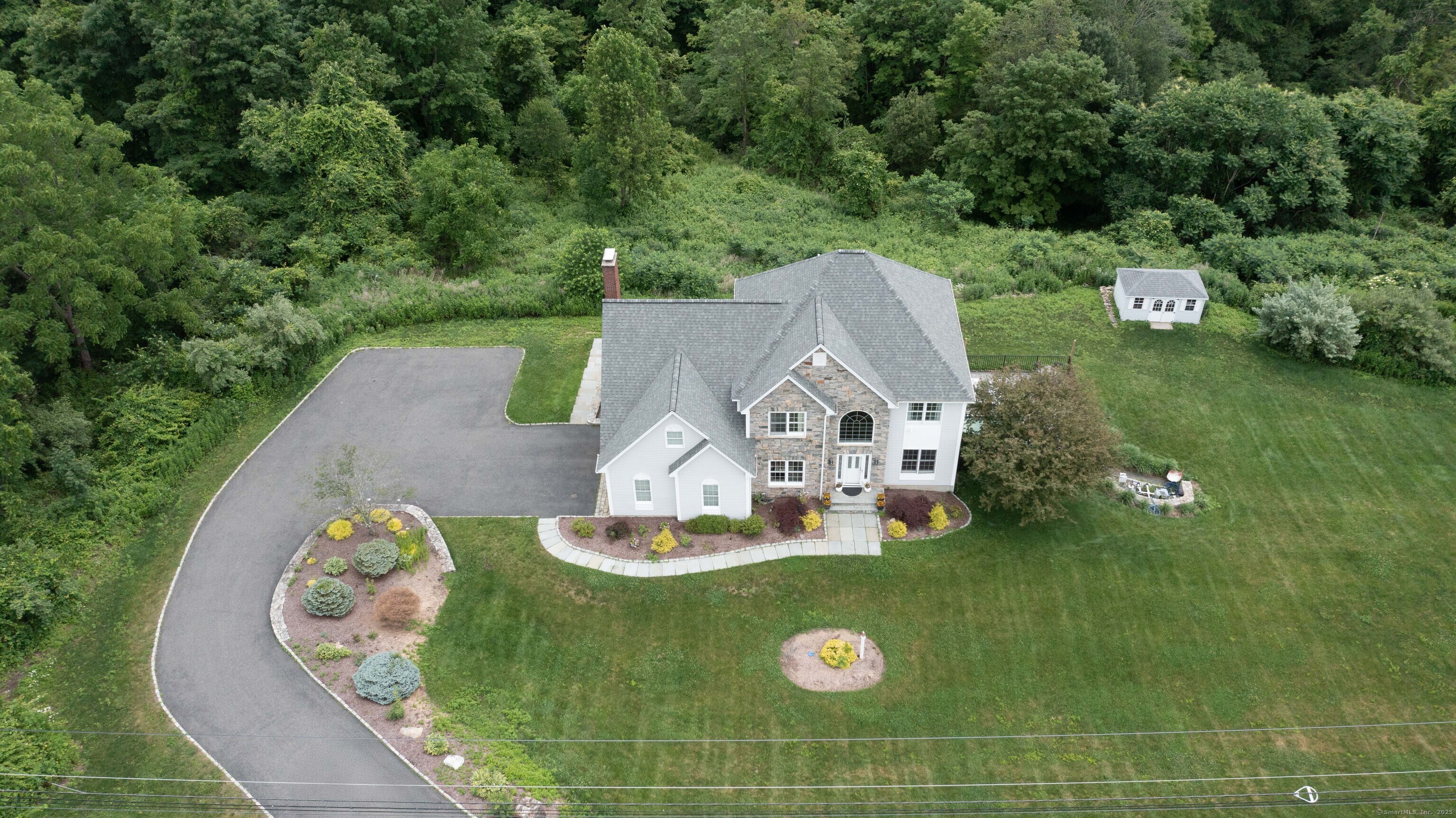 557 Upper Grassy Hill Road Woodbury, CT 06798 - Photo 3 of 40 an aerial view of a house with garden space and car parked