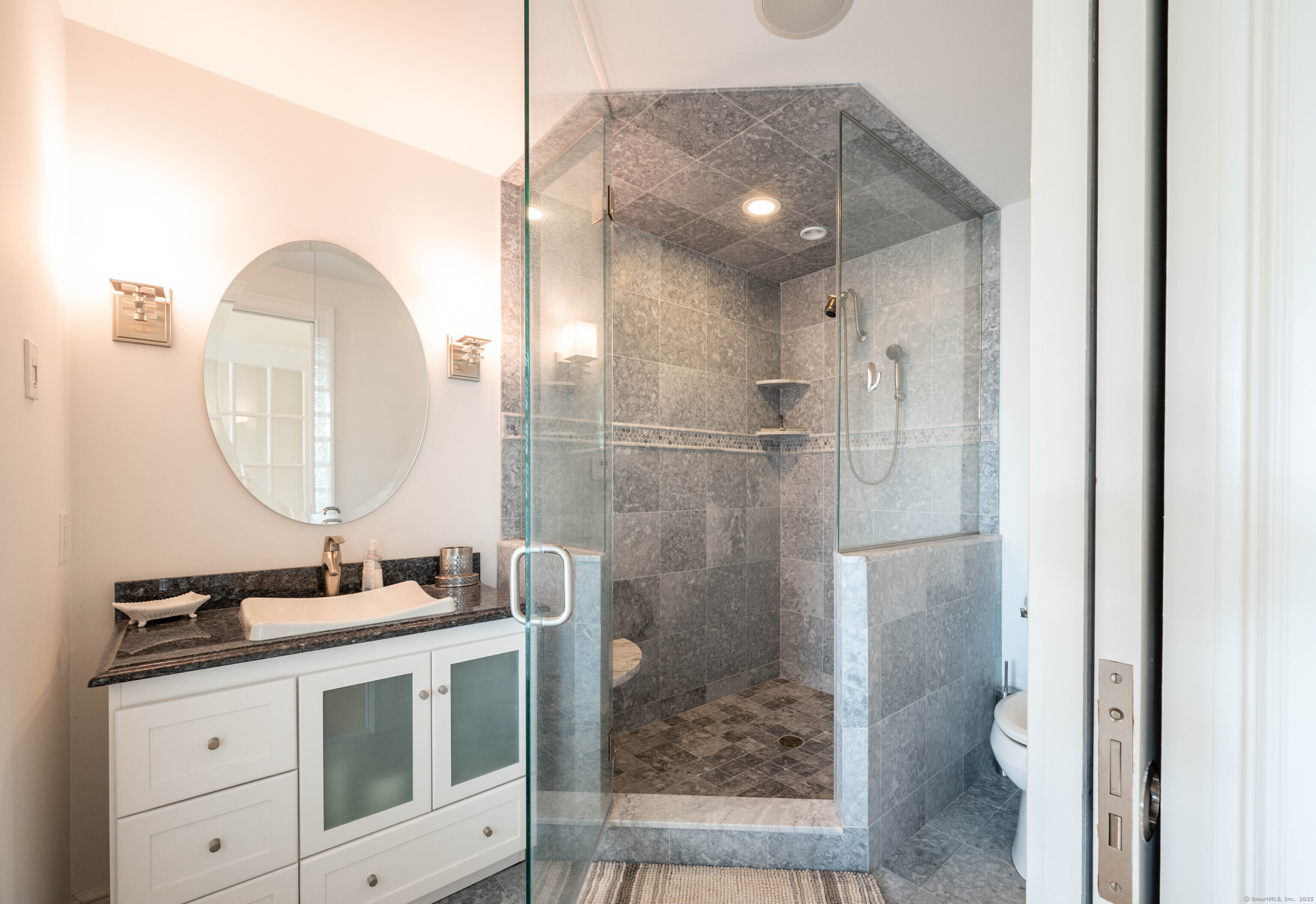 557 Upper Grassy Hill Road Woodbury, CT 06798 - Photo 32 of 40 a bathroom with a sink a toilet and a mirror