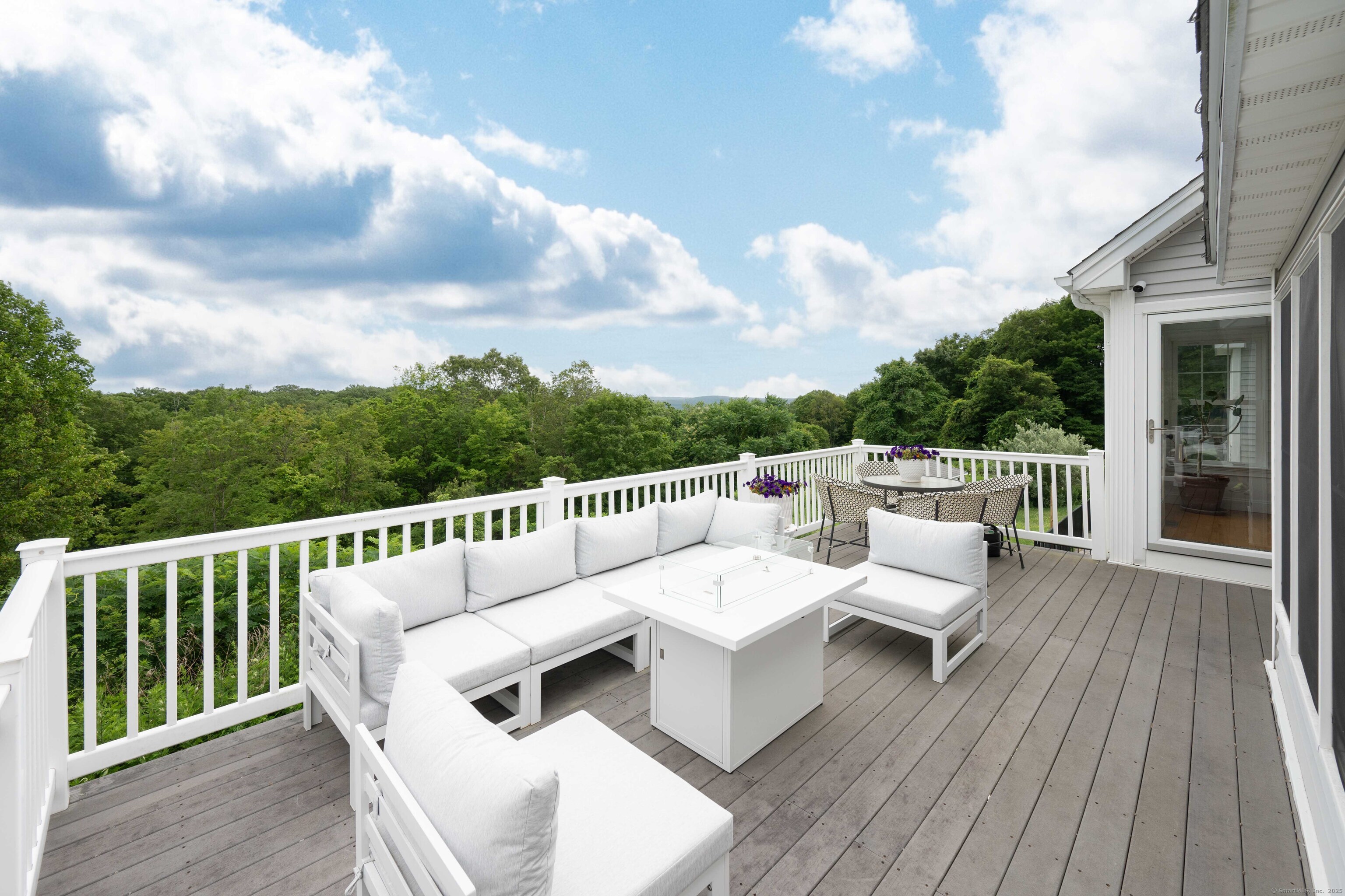 557 Upper Grassy Hill Road Woodbury, CT 06798 - Photo 33 of 40 a balcony with wooden floor and city view