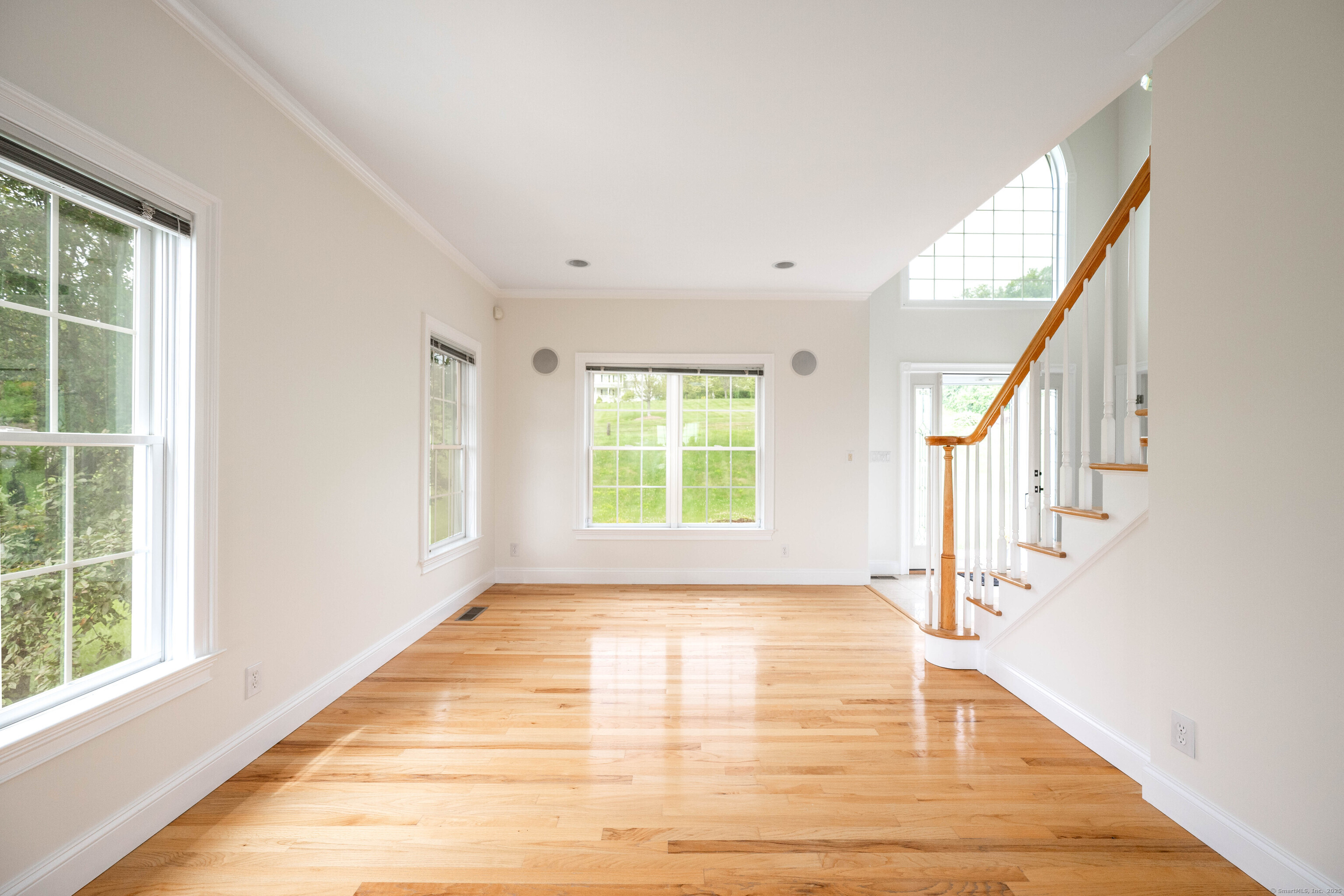 557 Upper Grassy Hill Road Woodbury, CT 06798 - Photo 6 of 40 a view of an empty room with wooden floor and a window