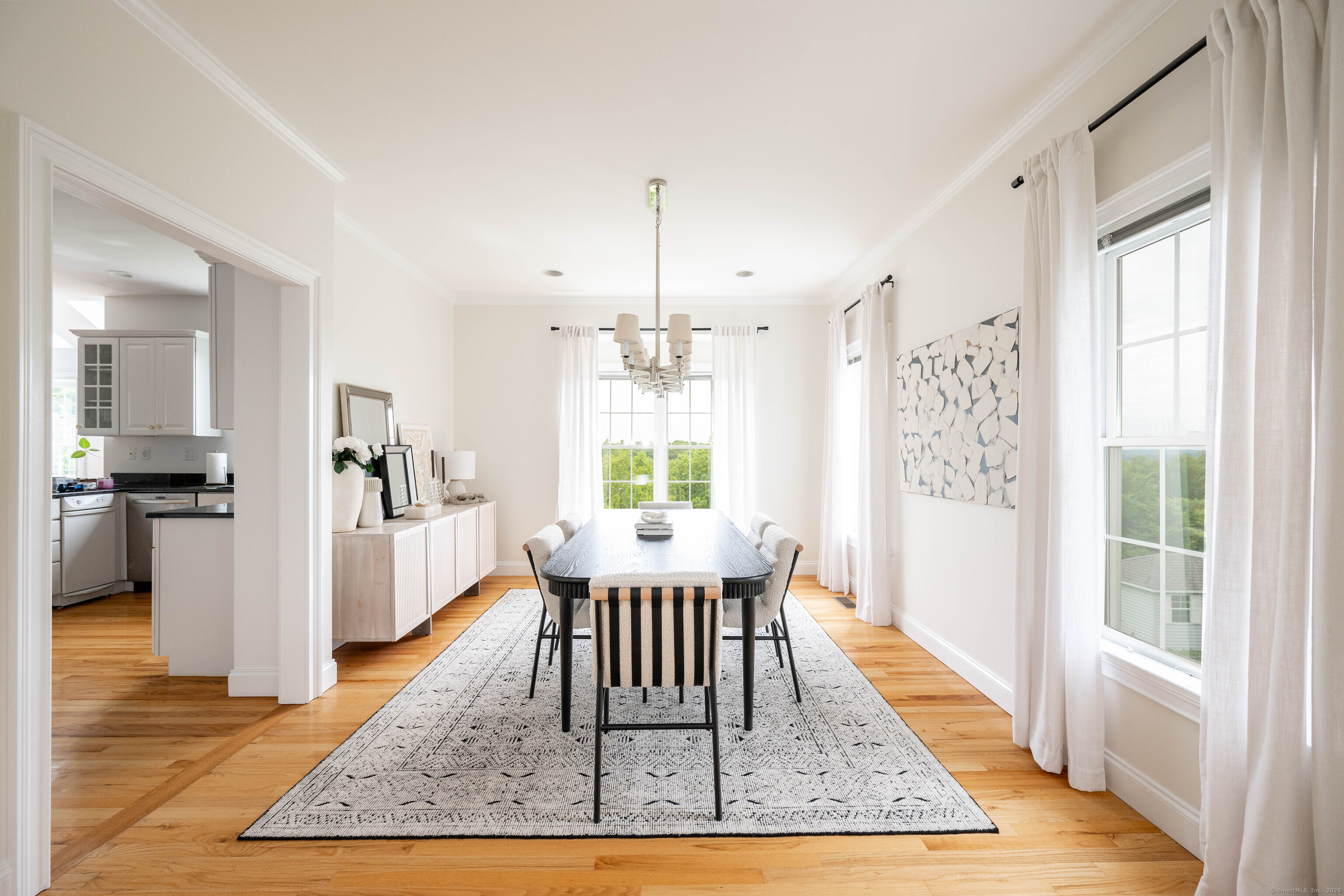 557 Upper Grassy Hill Road Woodbury, CT 06798 - Photo 7 of 40 a dining room with wooden floor and a rug
