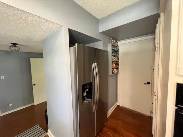 a view of walk in closet with wooden floor