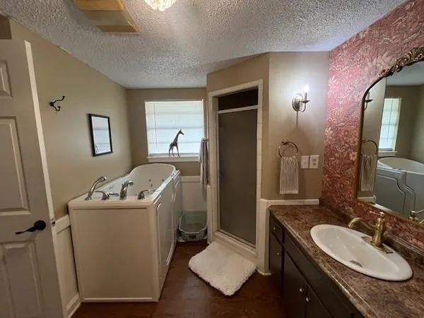 a bathroom with a sink and mirror with toilet