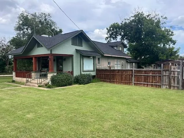 a view of a house with a yard and sitting area