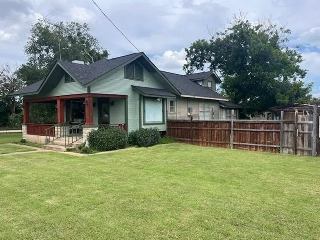 a view of a house with a yard and sitting area