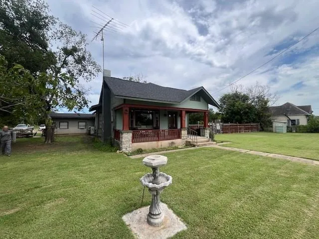 a view of a house with swimming pool and sitting area