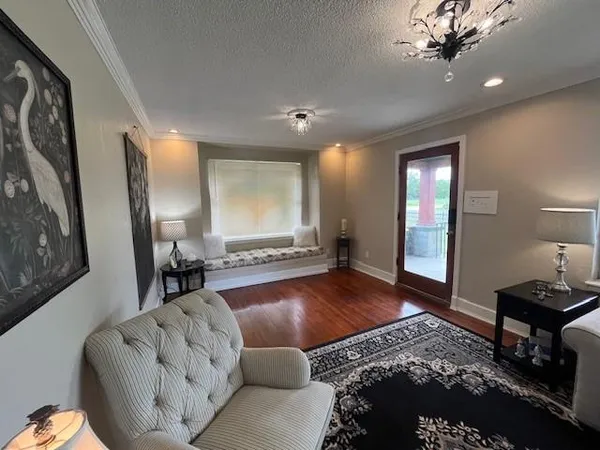 a living room with furniture and a wooden floor