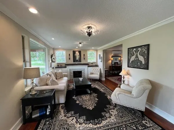 a living room with furniture fireplace and a window