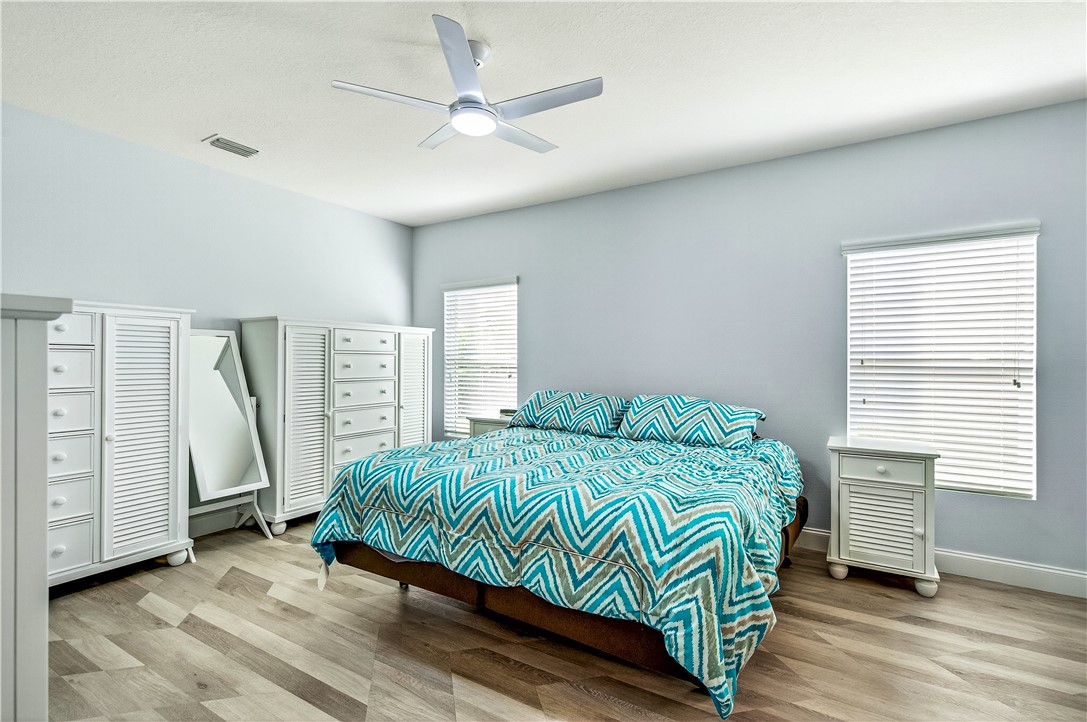 535 Valencia Circle Southwest Vero Beach, FL 32968 - Photo 18 of 36 a bedroom with a bed and a window