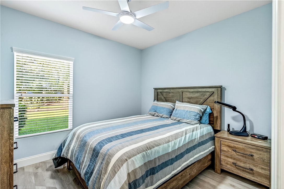 535 Valencia Circle Southwest Vero Beach, FL 32968 - Photo 21 of 36 a bedroom with a bed and a window