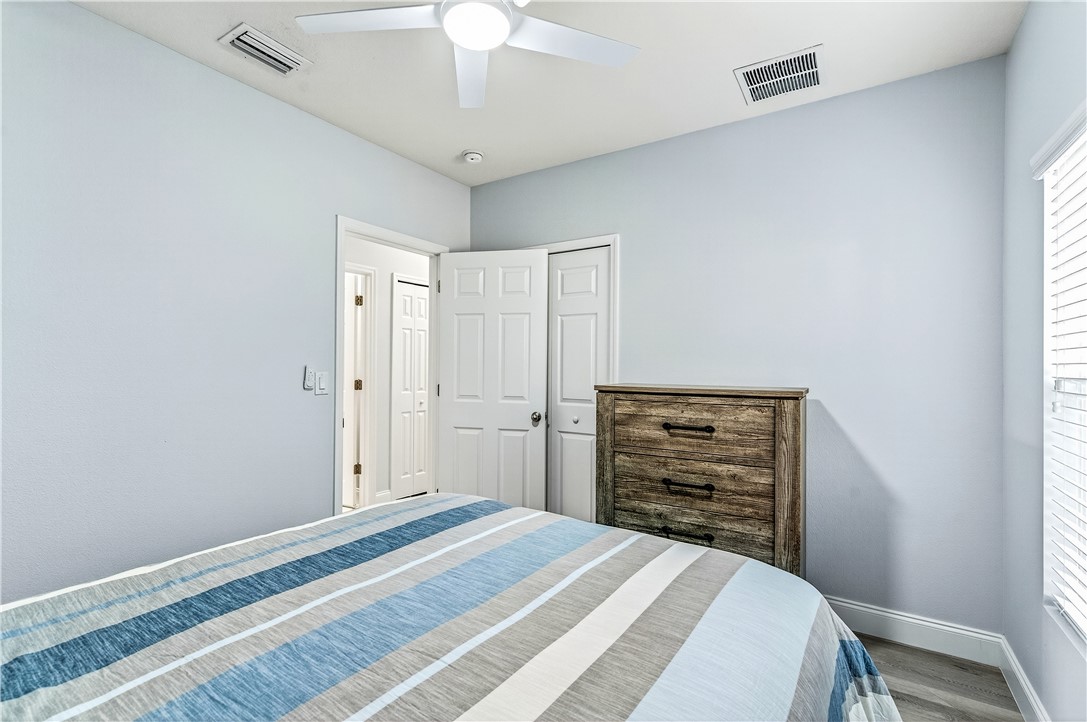 535 Valencia Circle Southwest Vero Beach, FL 32968 - Photo 22 of 36 a bedroom with a bed and a chandelier