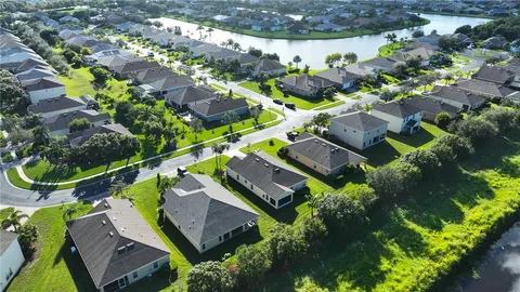 an aerial view of a house with a yard and outdoor seating