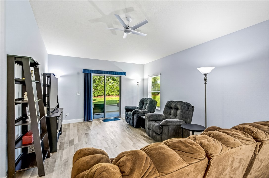 535 Valencia Circle Southwest Vero Beach, FL 32968 - Photo 6 of 36 a view of a livingroom with furniture and a ceiling fan