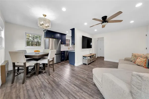 a living room with furniture and wooden floor