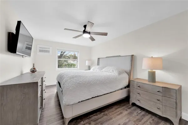 a large bed sitting in a bedroom and tv on a dresser