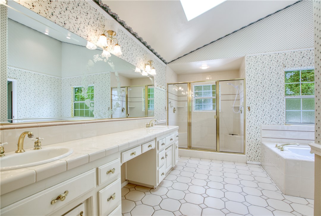 350 Corbett Canyon Road Arroyo Grande, CA 93420 - Photo 45 of 66 a spacious bathroom with a granite countertop sink mirror and a bathtub