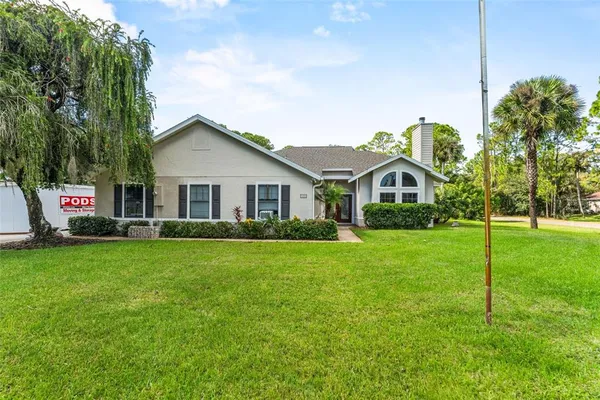 a front view of house with yard and green space