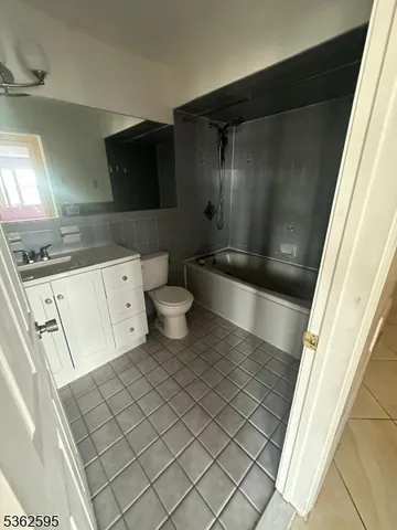a bathroom with a sink a toilet a mirror and shower