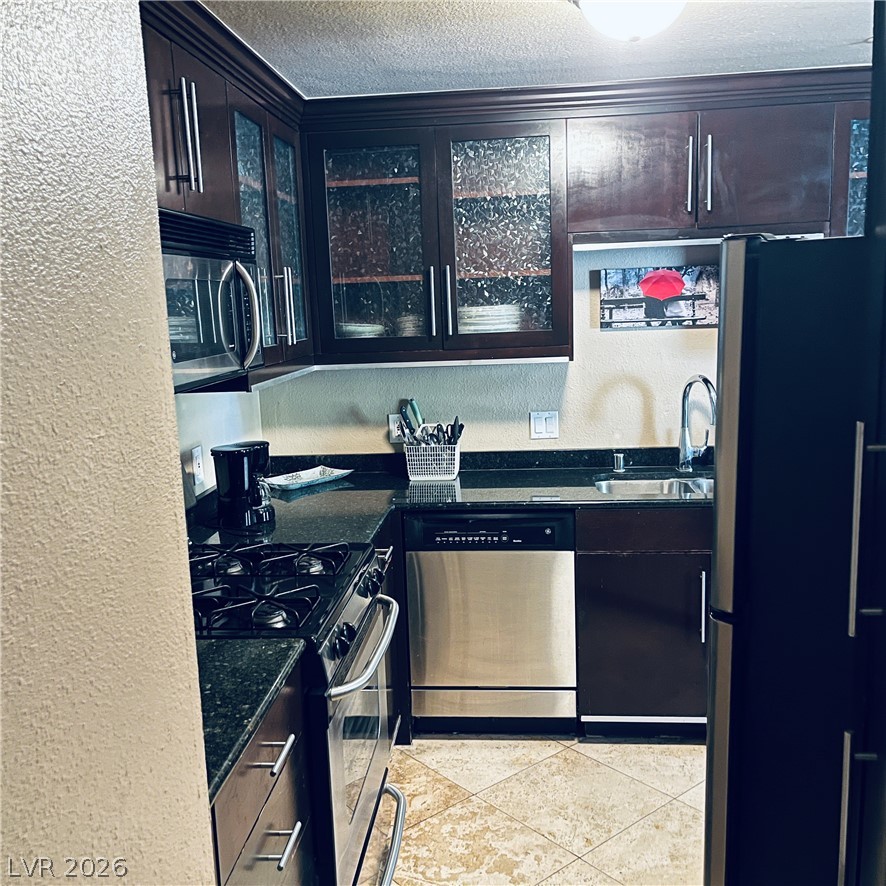 260 East Flamingo Road, Unit 118 Las Vegas, NV 89169 - Photo 6 of 9 Kitchen with dark cabinetry, granite counters, and stainless steel appliances.