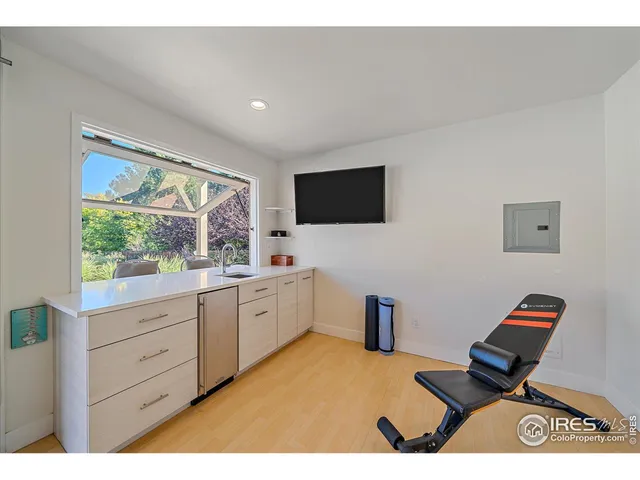 a bedroom with furniture and a flat screen tv
